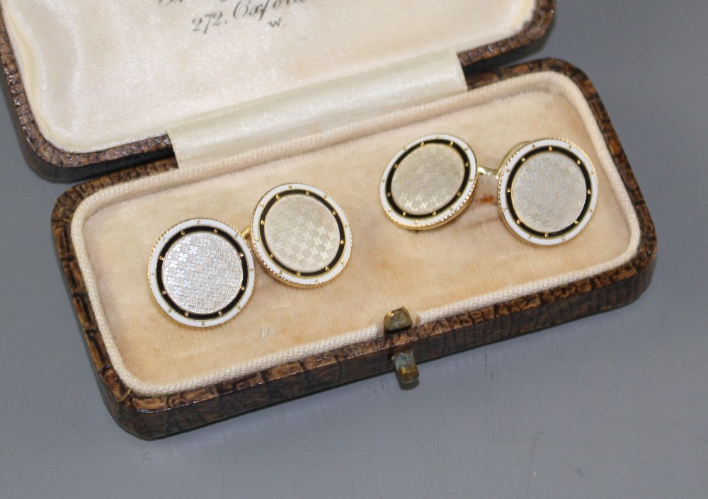 A pair of yellow metal (stamped TM 18ct), mother of pearl and enamel disc cufflinks, gross weight 10 grams, disc 14mm.